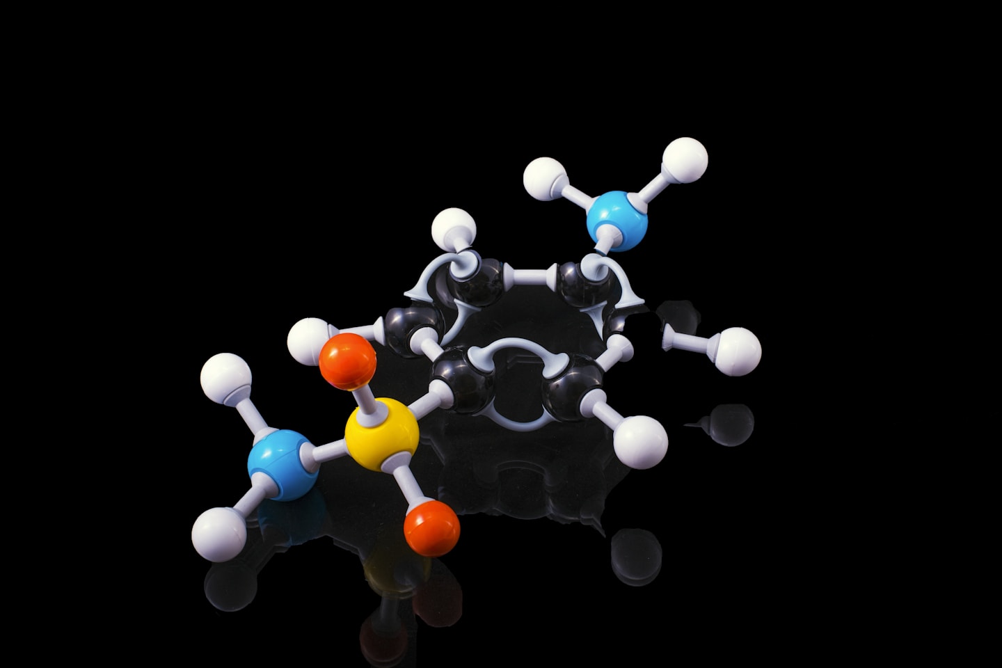 A molecule model with reflection on a dark surrounding. Sulfanilamide if someone is really interested !!
Sulfanilamide was a medicine used to treat streptococcal infections. One version of the drug, in liquid form, was introduced in the market after having being tested only for flavor, appearance and fragrance but not for toxicity. It caused the deaths of more than 100 people back in 1937. As we are all awaiting the cure for COVID19 let his be a reminder of what untested, unsafe and "rushed to market" drugs can do to people.