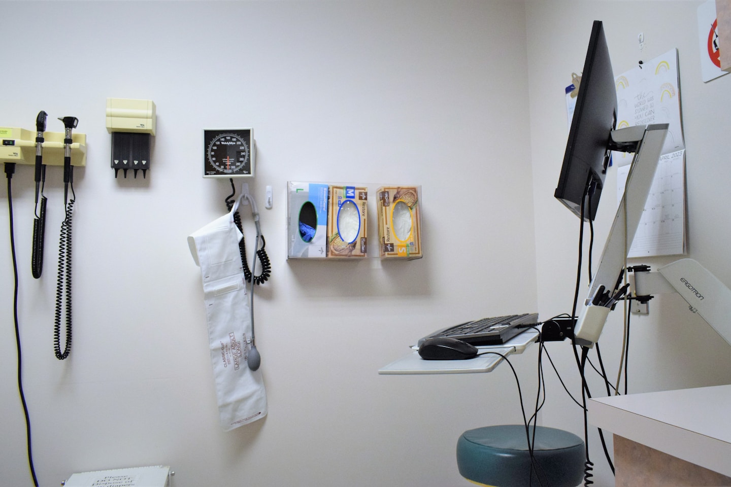 a room with a desk, phone, and other items on the wall